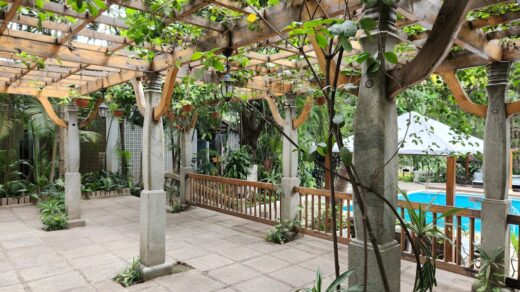 a patio with a pool in the background